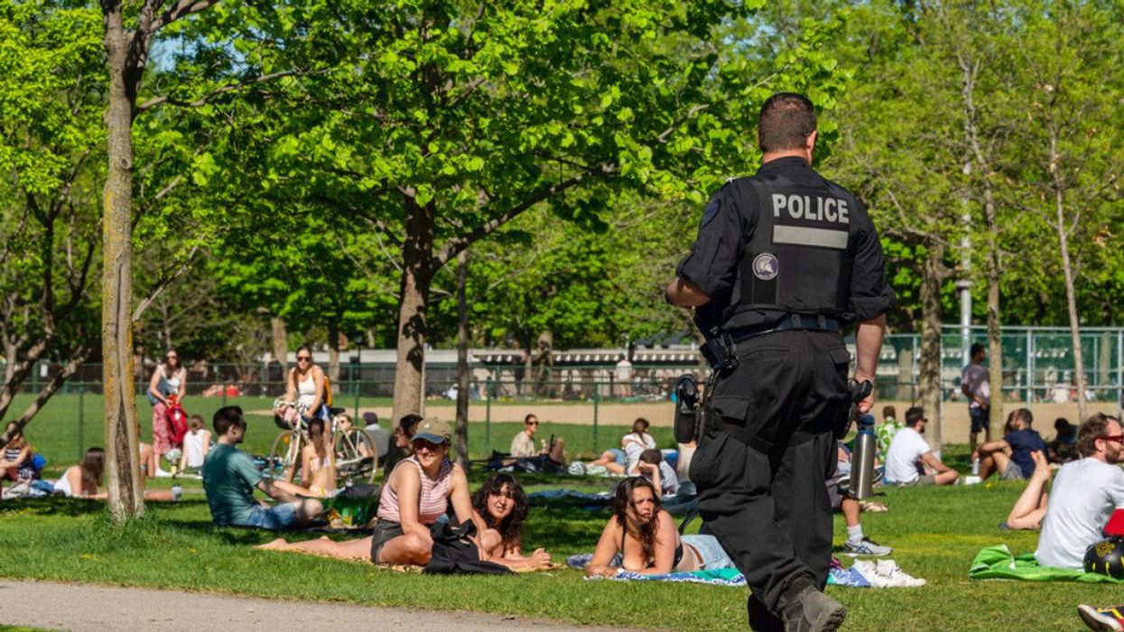 Police patrol Laurier park to enforce the coronavirus physical-distancing laws