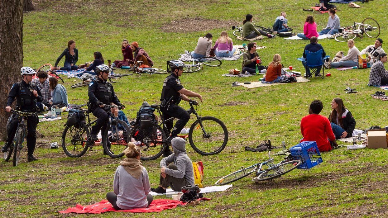 Police patrol public parks to enforce the coronavirus physical-distancing laws in Lafontaine Park