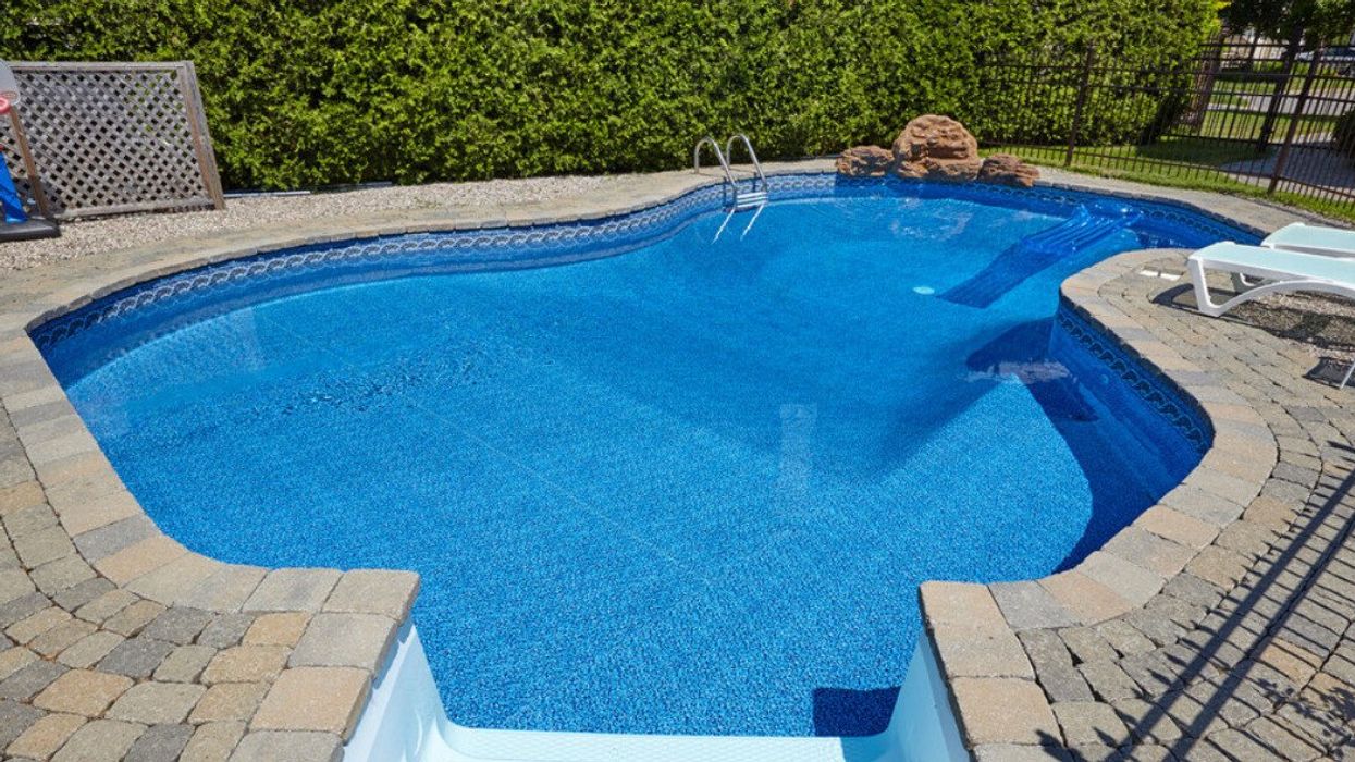 Private swimming pool with blue clear water.