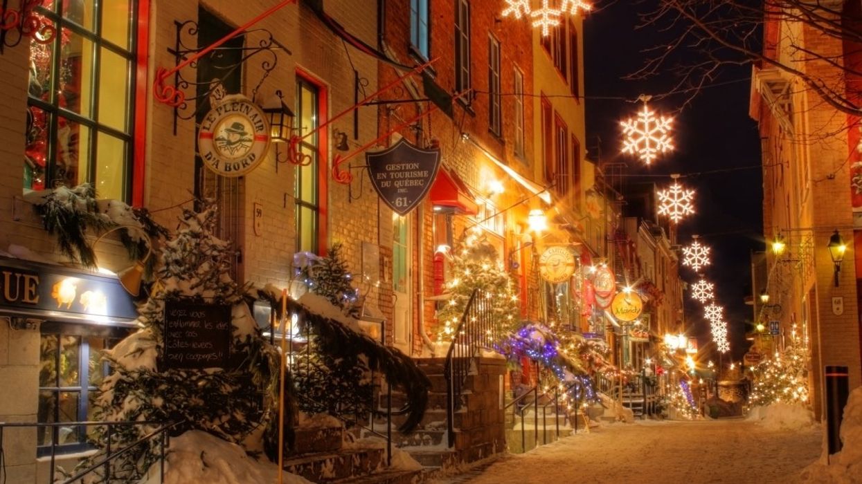 Quebec City at night with glimmering holiday lights lining up the streets during the winter.
