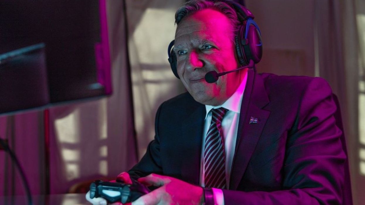 Quebec Premier François Legault holding a gamer controller and wearing a gamer headset.