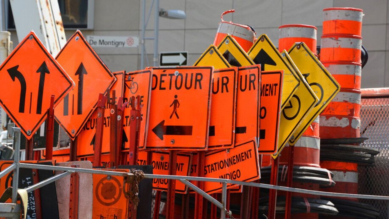 Road signs and orange cones in downtown Montreal.