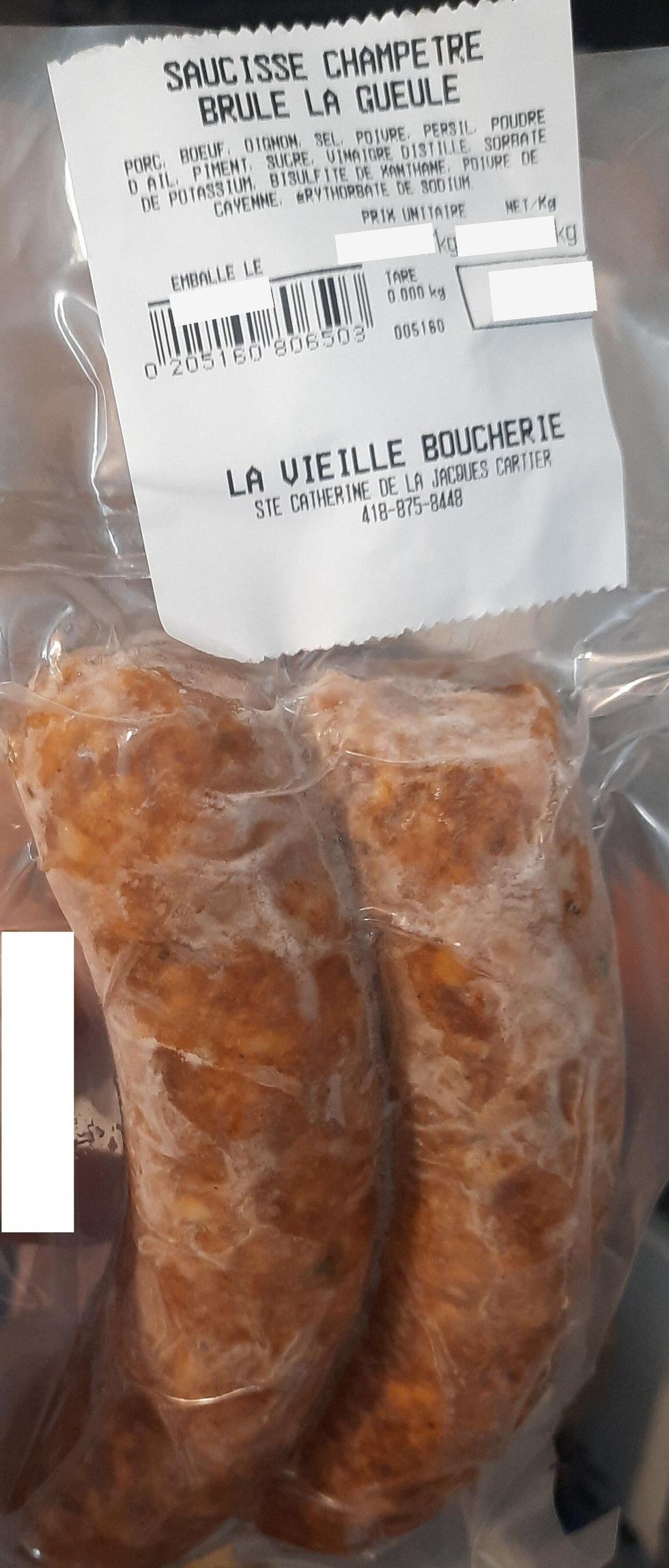 Sausage on display at a deli counter.