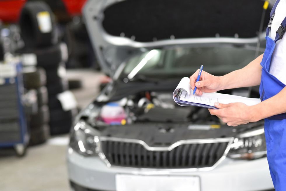 Service and inspection of a car in a workshop.