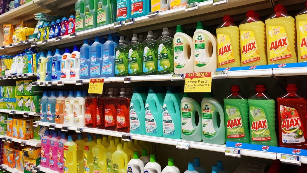 Several cleaning products stacked atop shelves in a Quebec grocery store. 