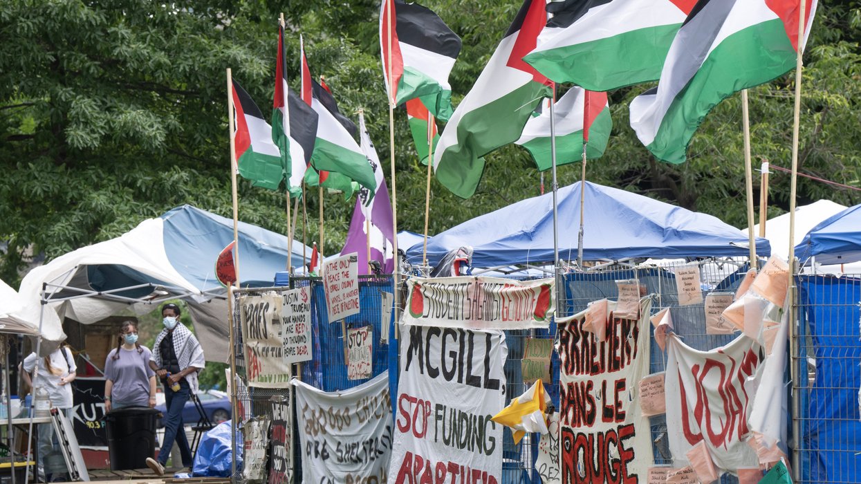 Signs and flags displayed at a pro-Palestinian protest encampment at McGill University.