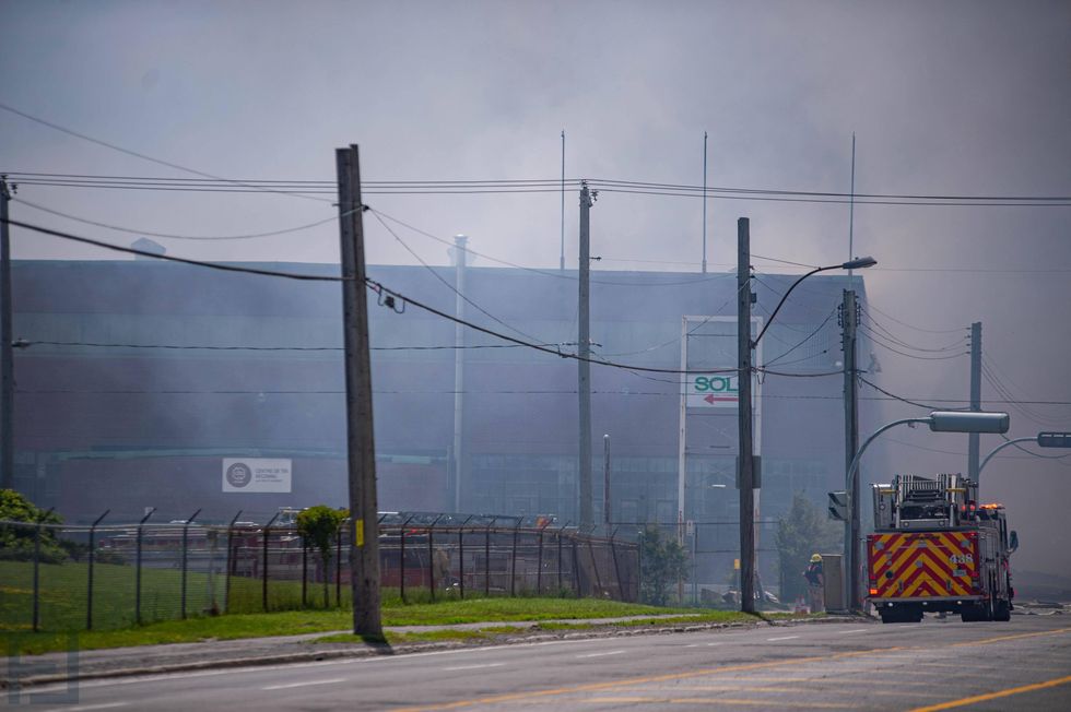 Smoke surrounds the area of a five-alarm fire in Montr\u00e9al-Est as firefighters respond on June 26.