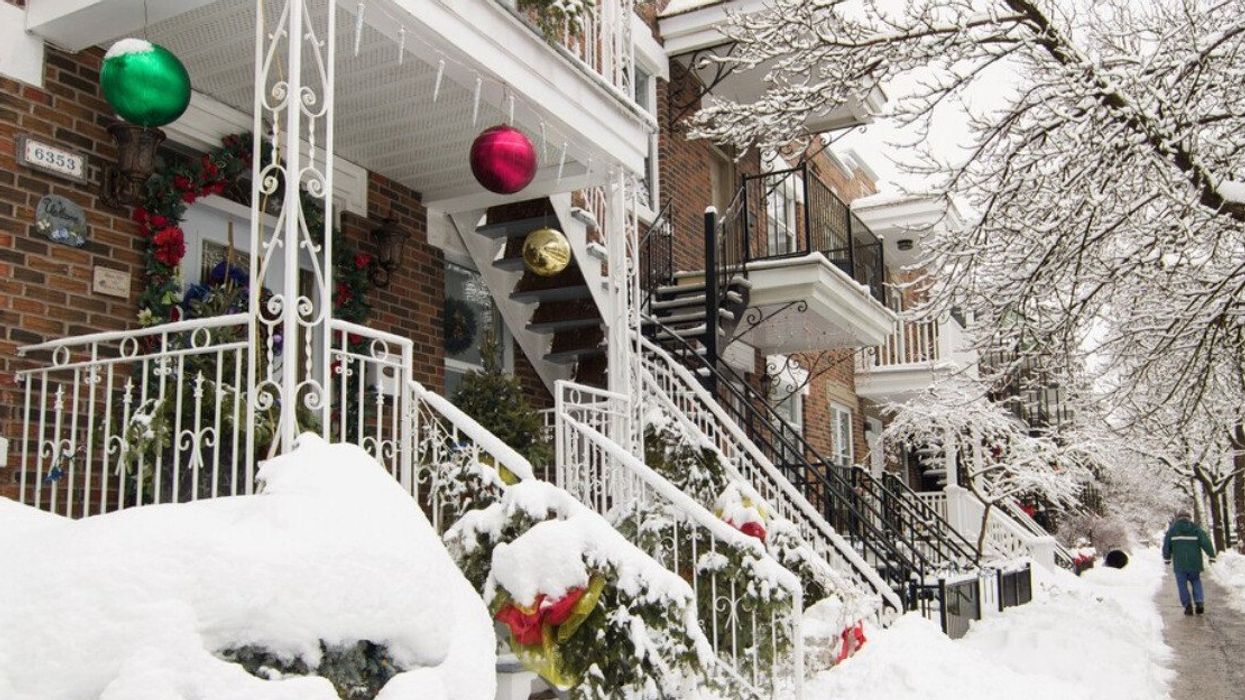 Snow-covered Christmas decorations on an apartment balcony in Montreal.
