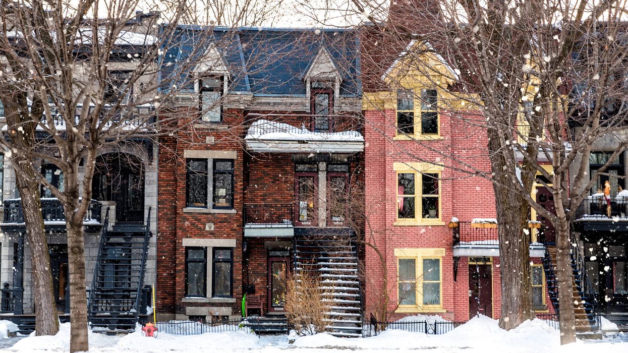 Snow falling on a Montreal street full of row houses and low-rise apartment buildings (illustrative).