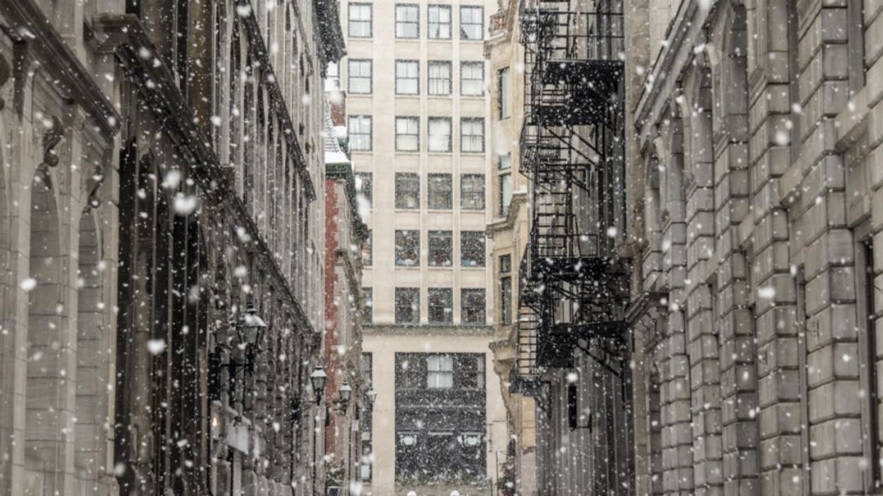 Snow falls on a Montreal street.