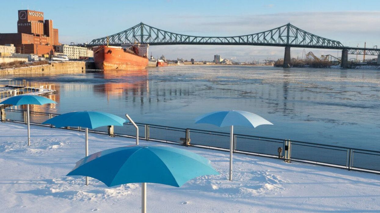 Snow on the Old Port Clock Tower Beach overlooking an icy Saint-Lawrence River and Jacques-Cartier Bridge.