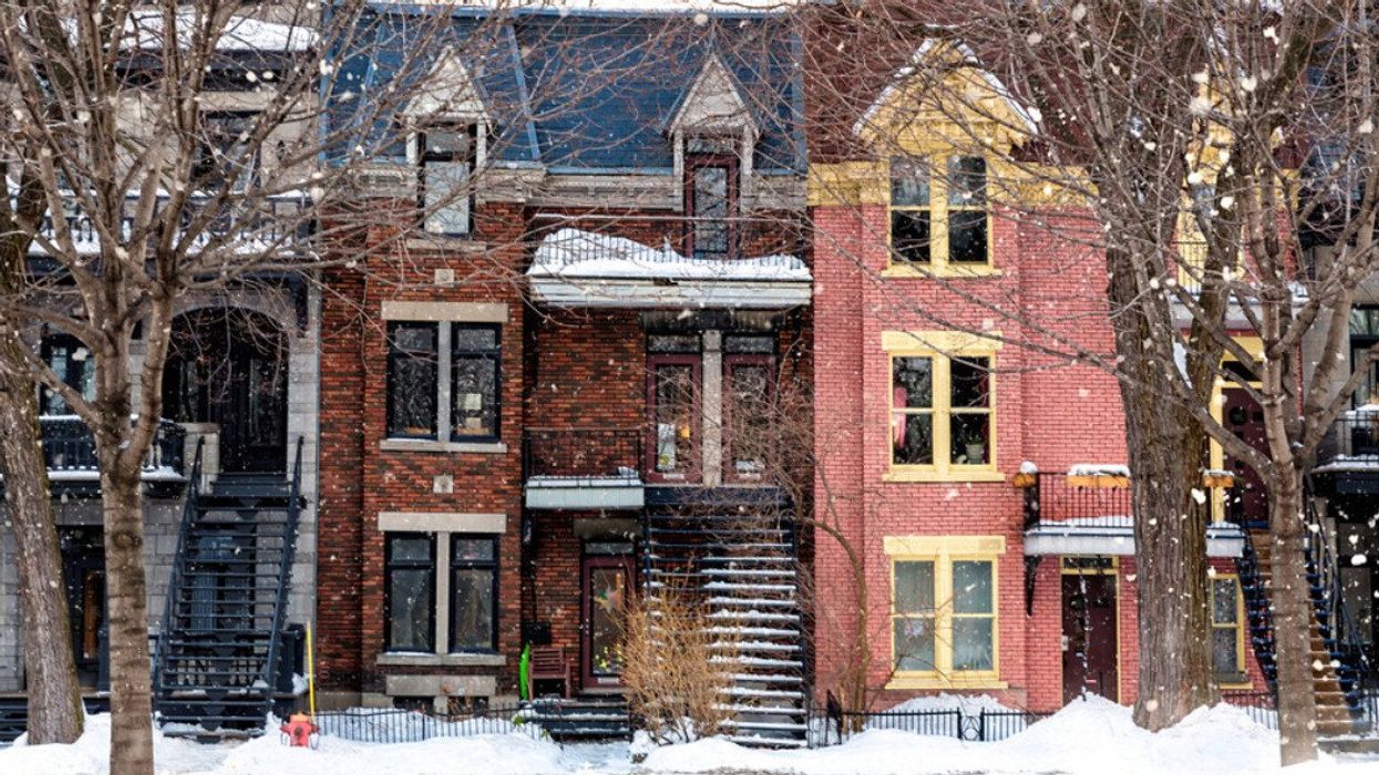 Snowfall in a Montreal street. Winter scene of traditional architecture. Winter street in Montreal, with traditional style architecture, snow covered balconies and heavy snowfall.