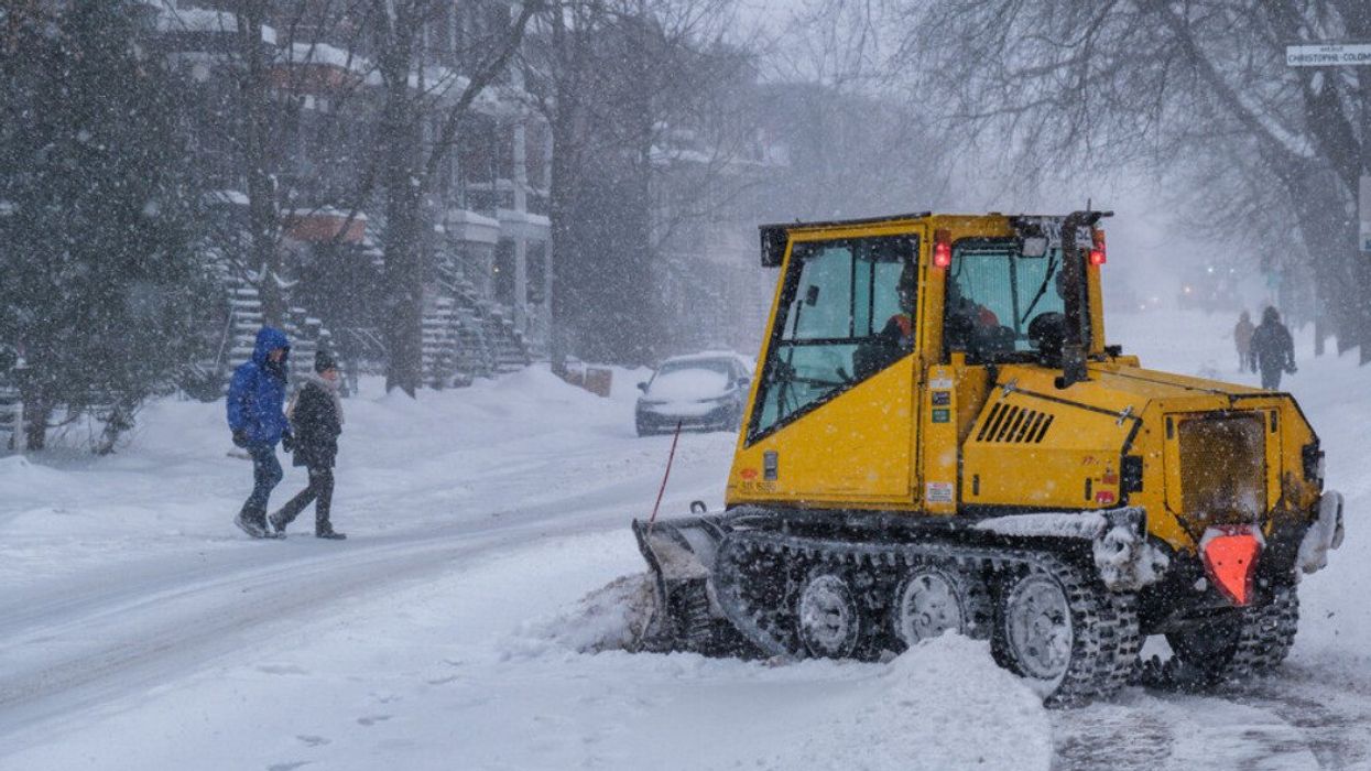 Snowplough removing snow during blizzard in Montreal.