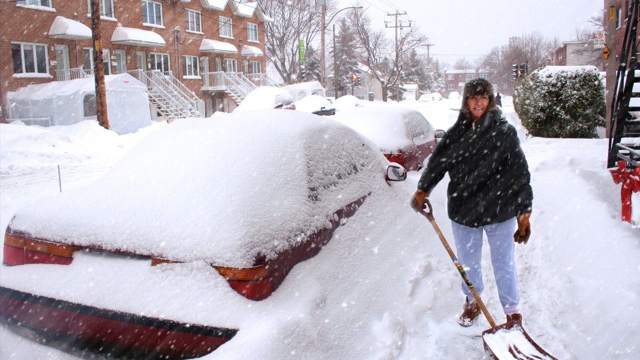 Snowstorm in Montreal during the winter and woman in the snow.