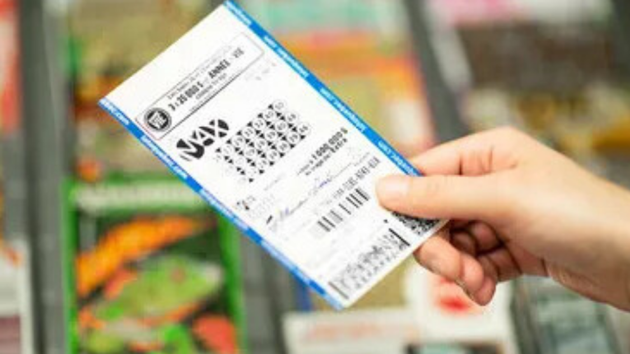 Someone holding a Lotto Max lottery ticket.
