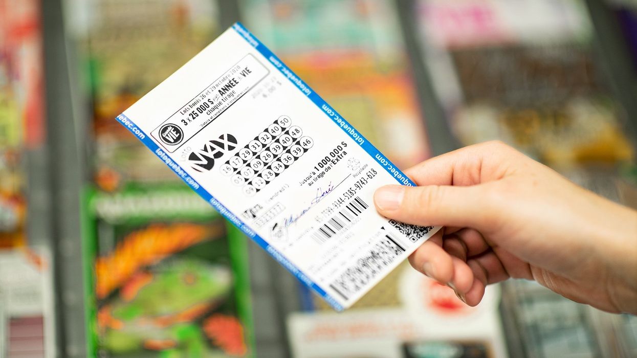 Someone holding a Lotto Max ticket (illustrative).