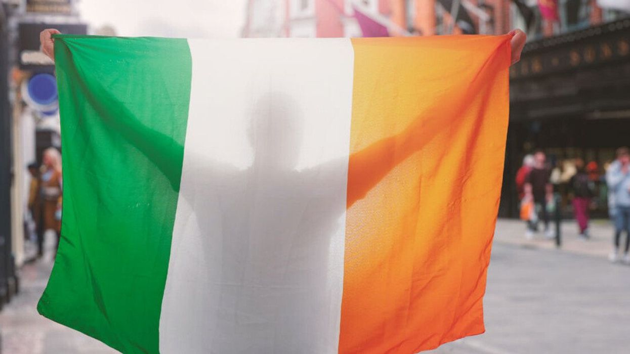 Someone holds up an Irish flag on Grafton Street in Dublin.