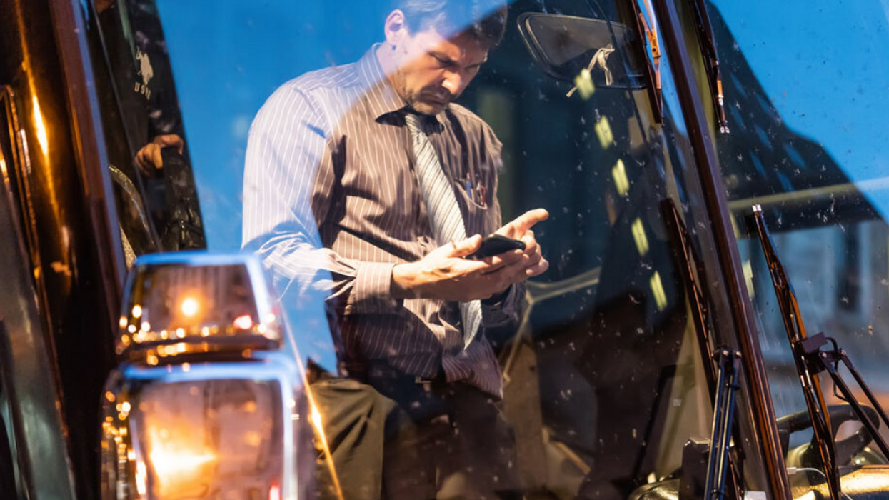 Someone looks angrily at their phone.