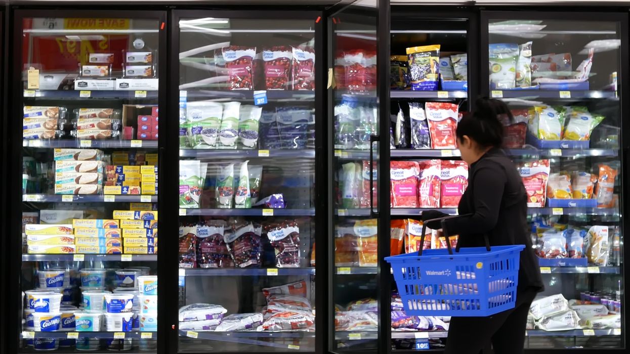 Someone shopping in the frozen food aisle of a Walmart (illustrative).