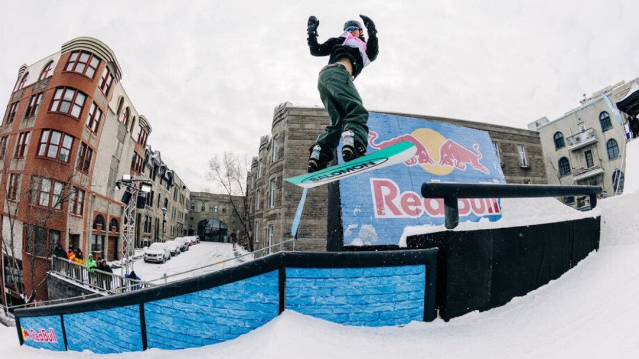 Someone snowboards down rue Saint-Denis in Montreal.