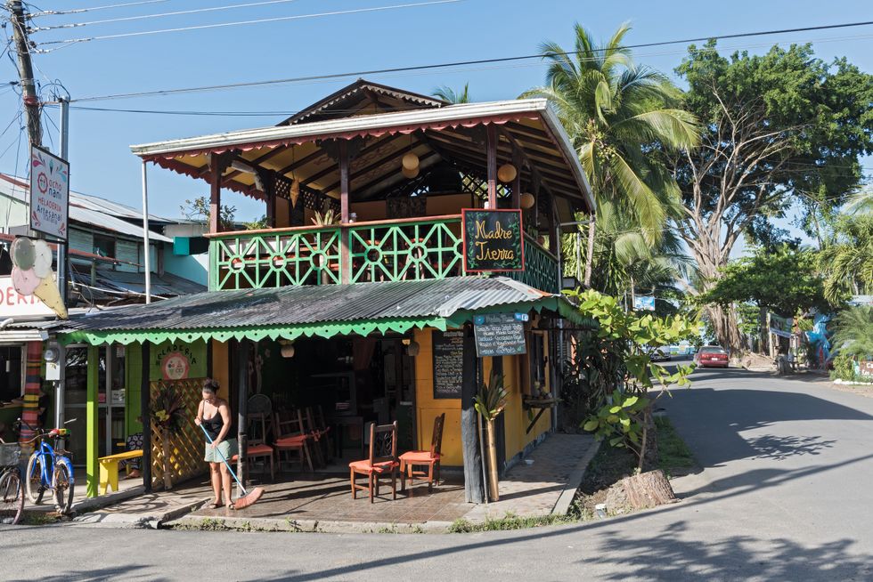 Someone sweeps outside a building in Puerto Viejo, Costa Rica.
