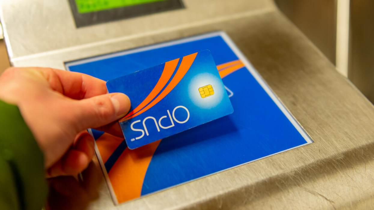 Someone taps their OPUS Card to access the Montreal metro.