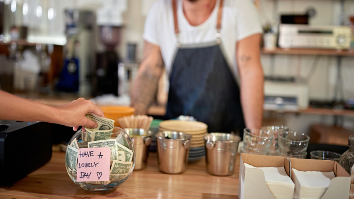 Someone tips a barista.