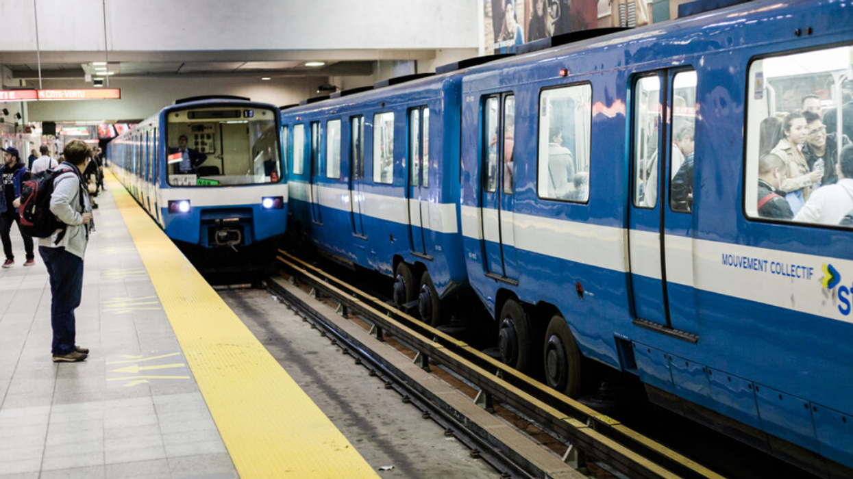 Someone waits inside Montreal's Berri-UQAM metro station, as a train pulls up.