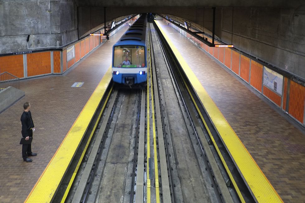 Someone waits on a metro platform for a train to stop at Assomption station.