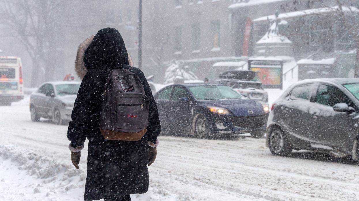 Someone walking through a snowstorm in Montreal (illustrative).