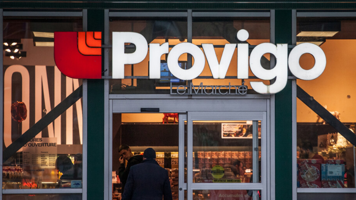Someone walks through the front doors of a Loblaw-owned Provigo grocery store, located in Montreal.