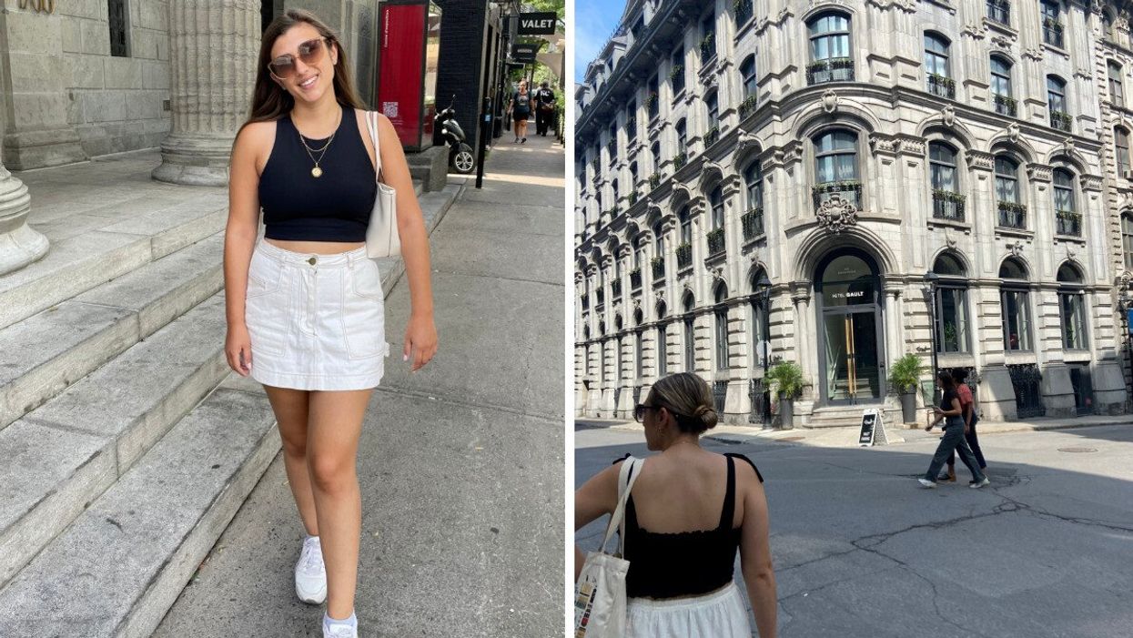 Someone wearing a white skirt and black top in Montreal standing in the street and walking by a historic Montreal building.