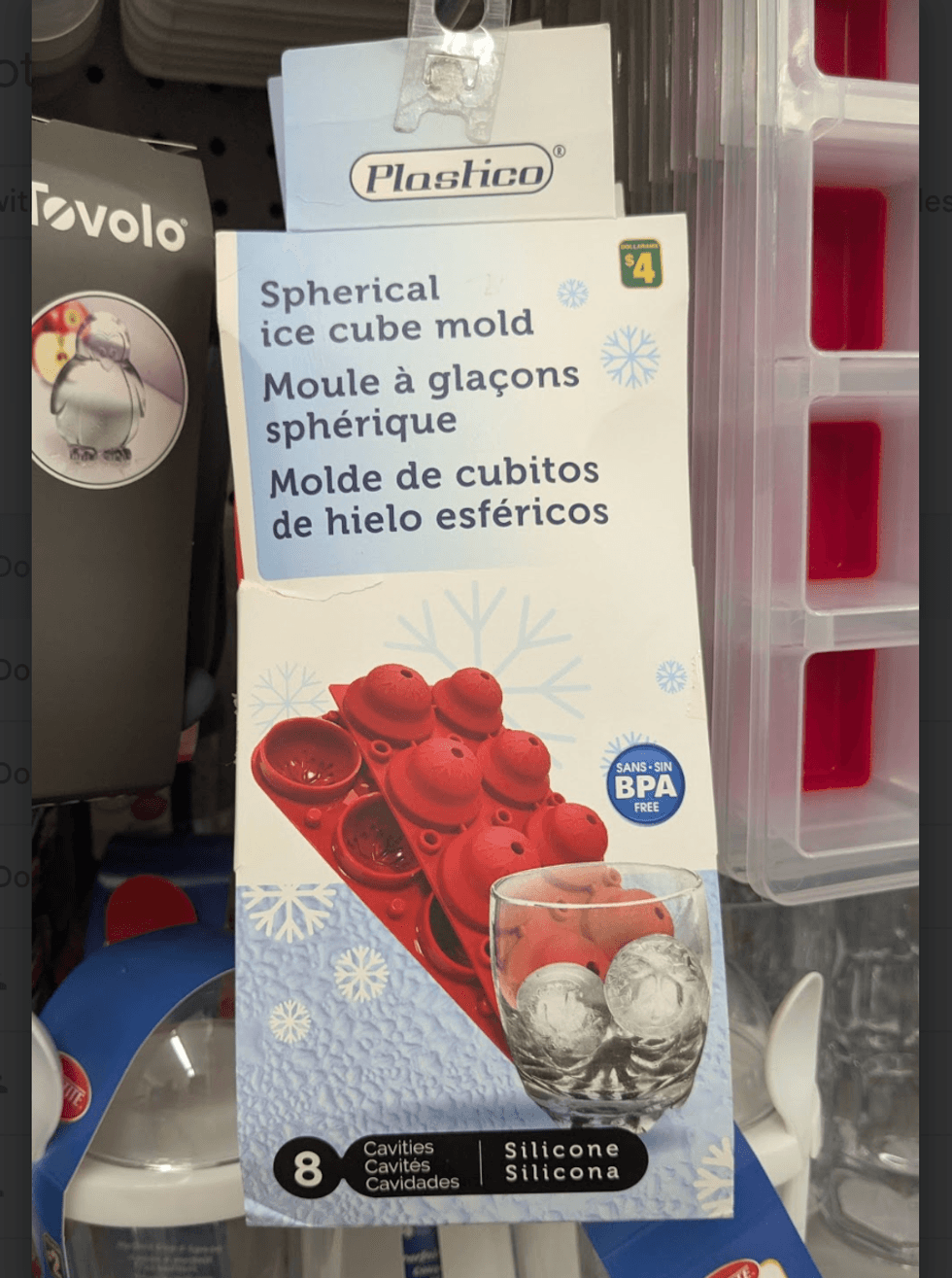 Spherical ice cube molds in a clear plastic tray