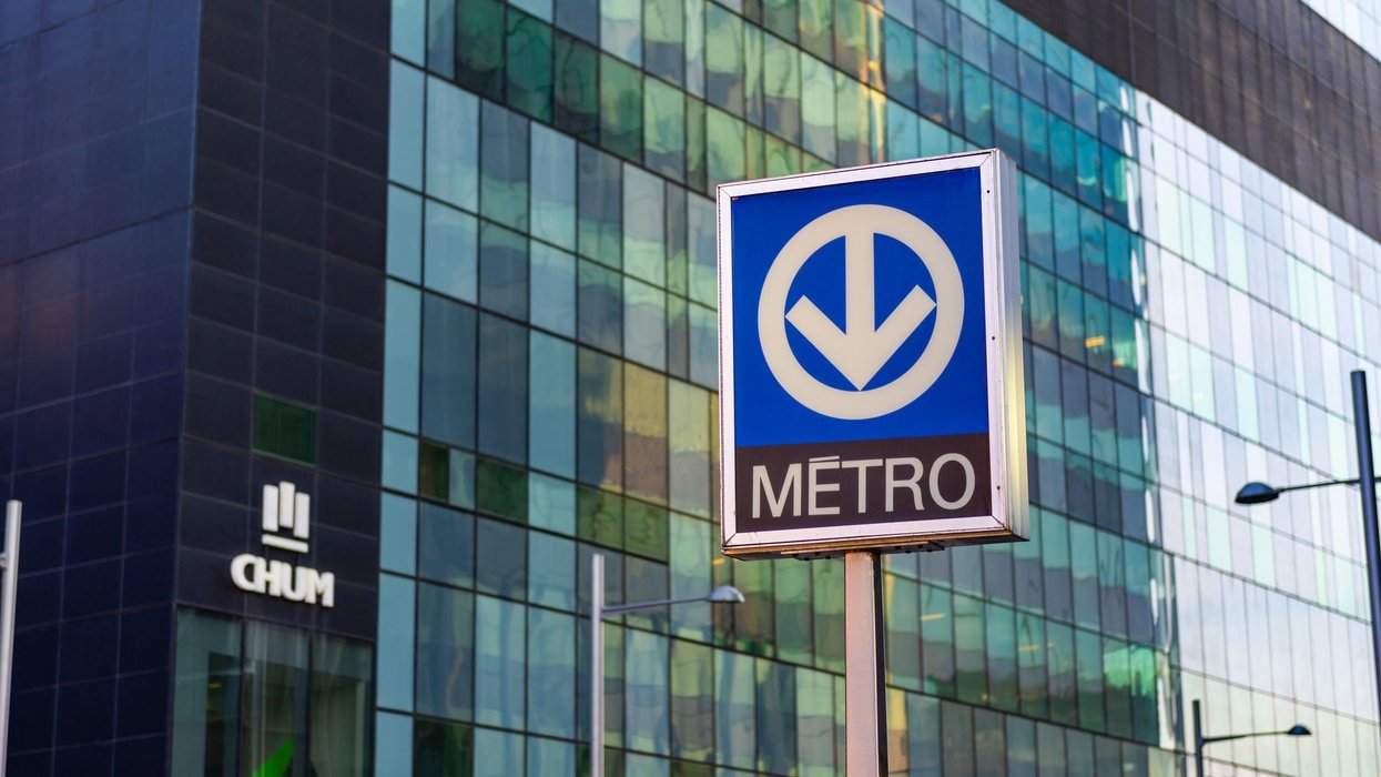STM metro sign on building backdrop. Montreal Quebec Canada April 17 2020: STM metro signs isolated showing that there is a metro stop with chum in background