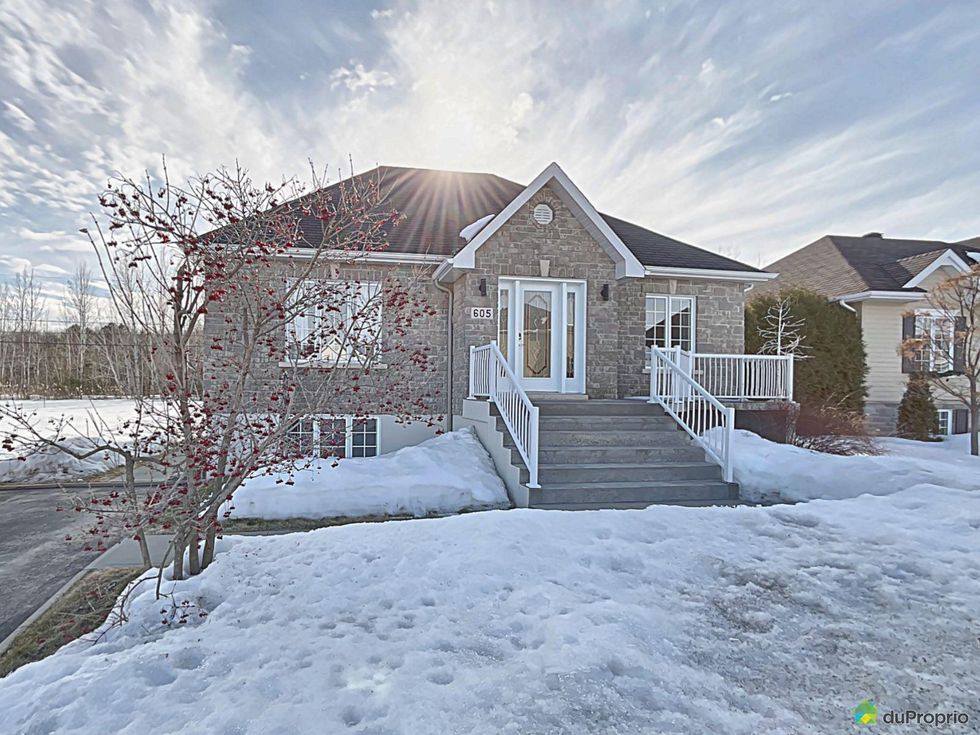 Stone-fa\u00e7ade, one-storey single-family home in Trois-Rivi\u00e8res, Quebec.