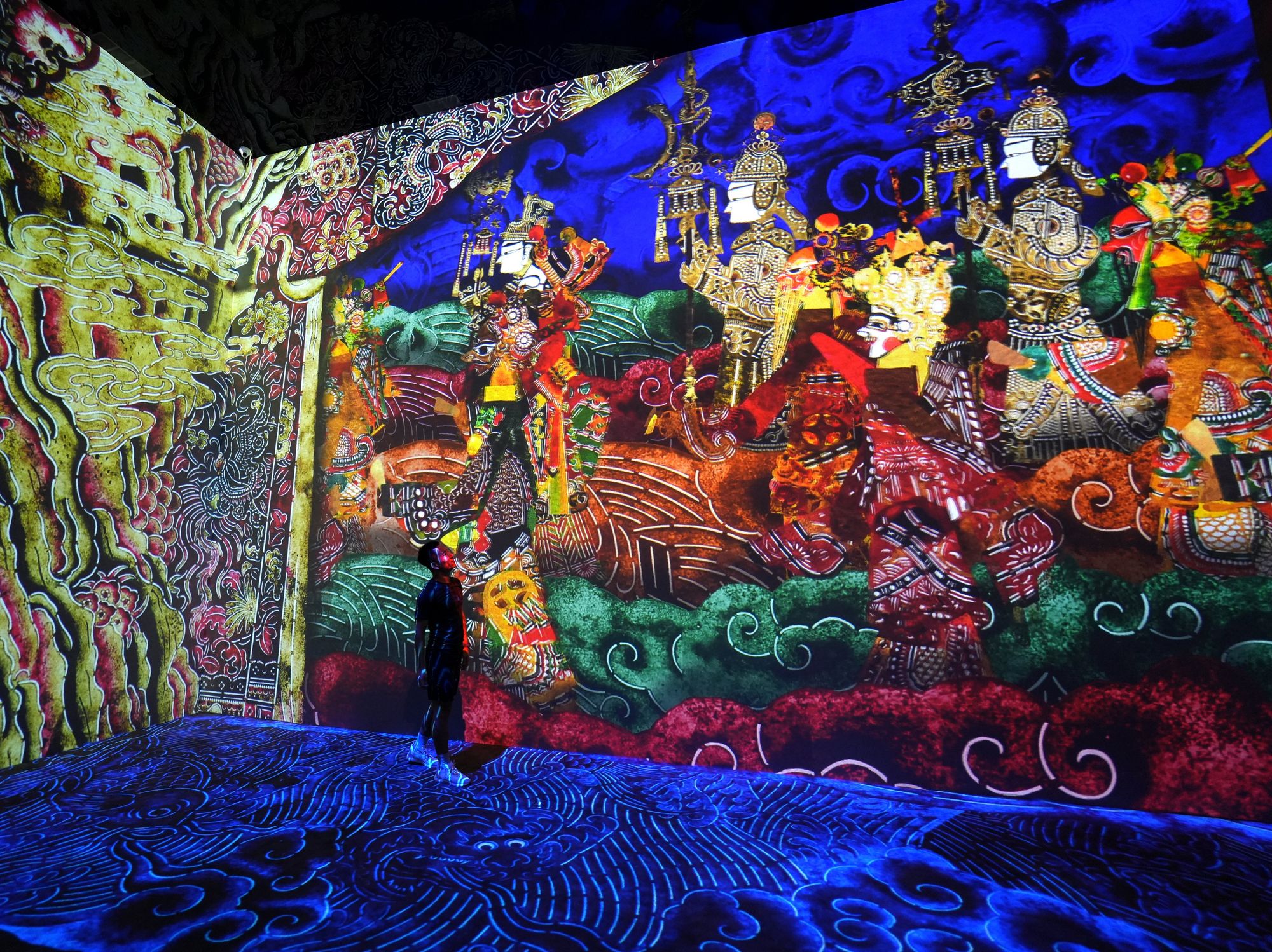 Sylized characters walk on the walls, while hand-drawn water sloshes around the floor of the exhibit.