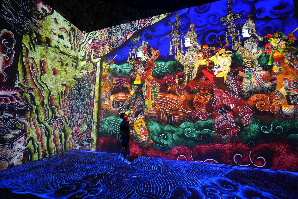 Sylized characters walk on the walls, while hand-drawn water sloshes around the floor of the exhibit.