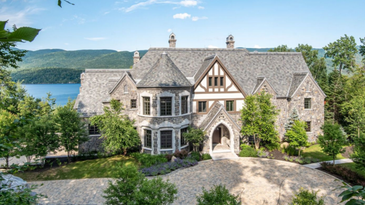 The $33.9 million mansion in Quebec sits on the lakeshore surrounded by trees.