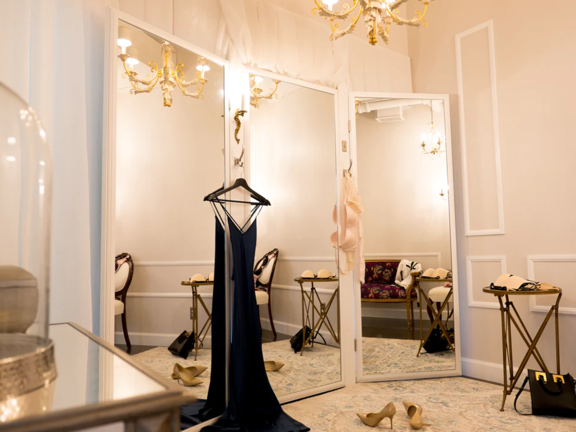 The "Alice" dressing room with a night gown hanging on a mirror and stilettos on the floor.