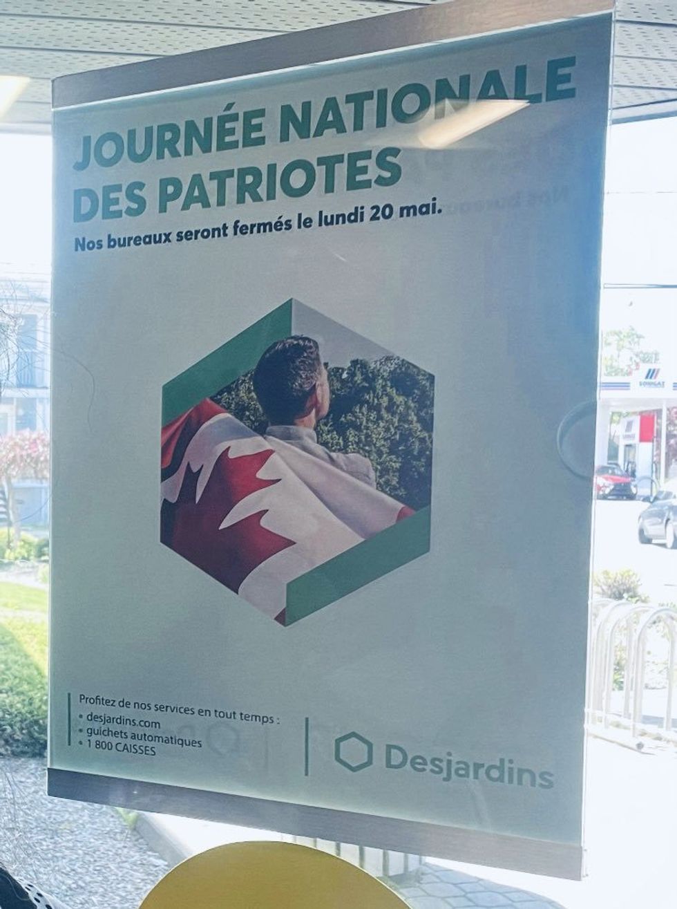 The controversial Desjardins poster hangs on a window.