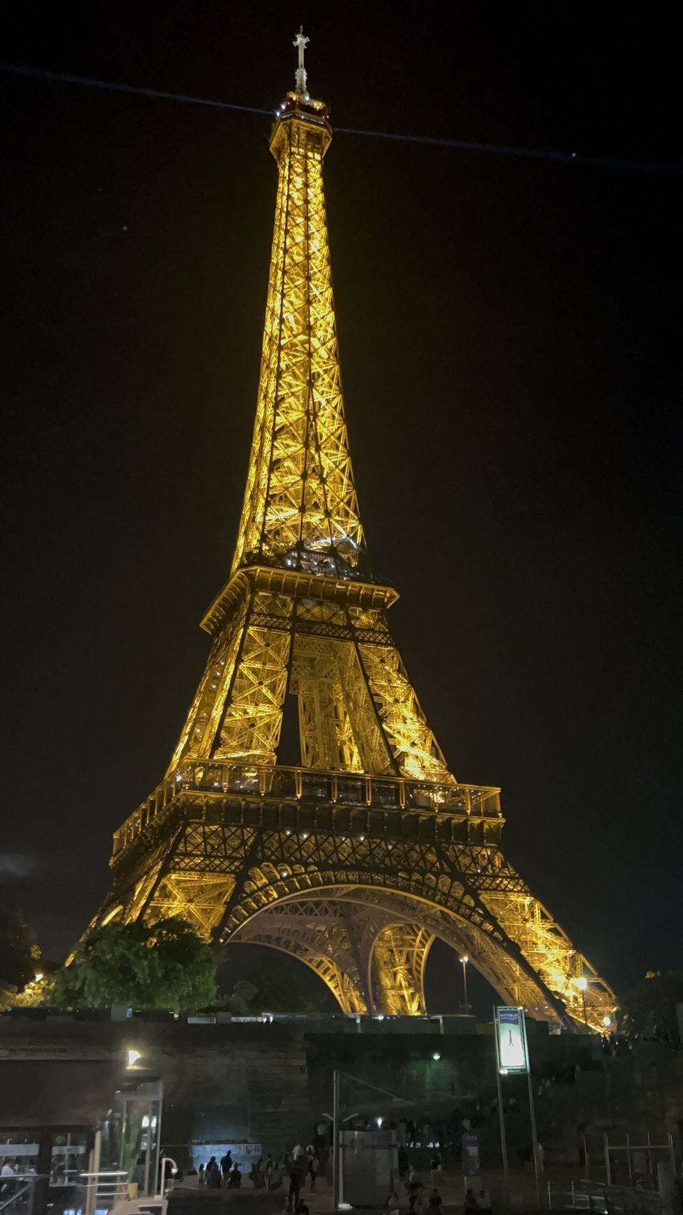 The Eiffel Tower glowing at night in Paris.