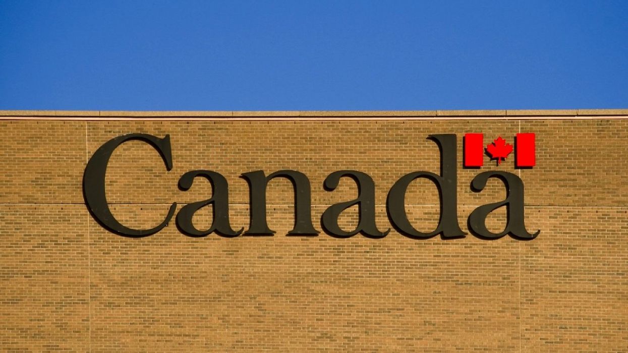 The exterior of a Government of Canada building and watermark logo of the Canadian flag.