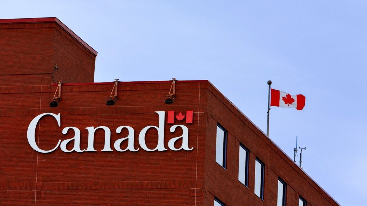 The exterior of a Government of Canada building with a Canadian flag on the roof.