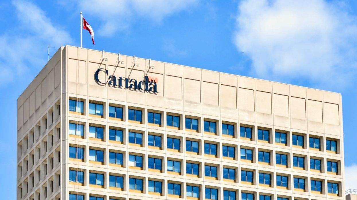 The exterior of a Government of Canada building with a Canadian flag on the roof.