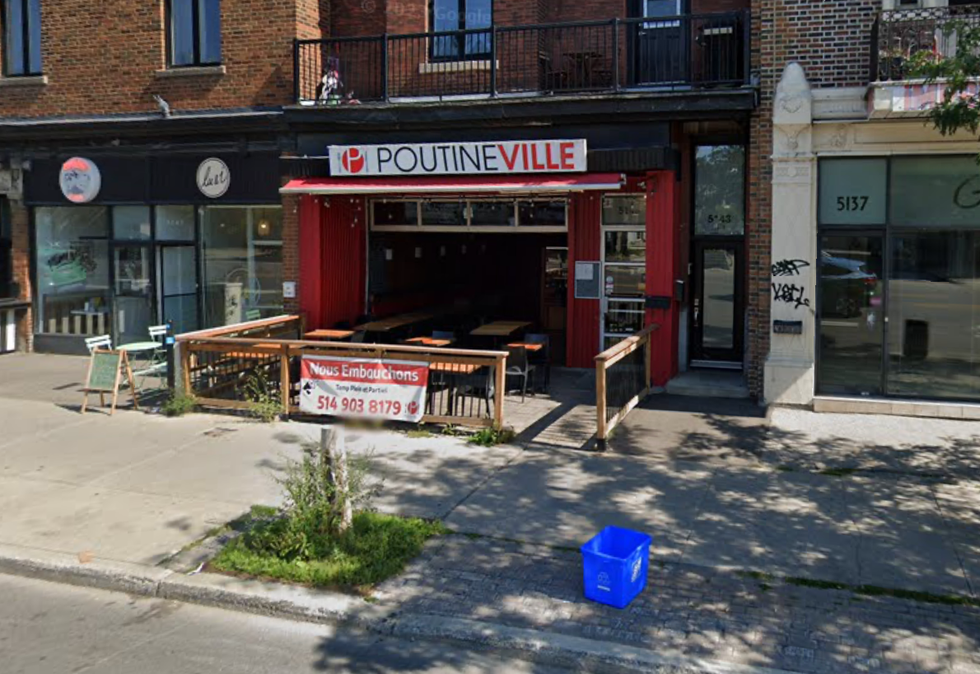 The exterior of a poutine restaurant on a busy street in Montreal.
