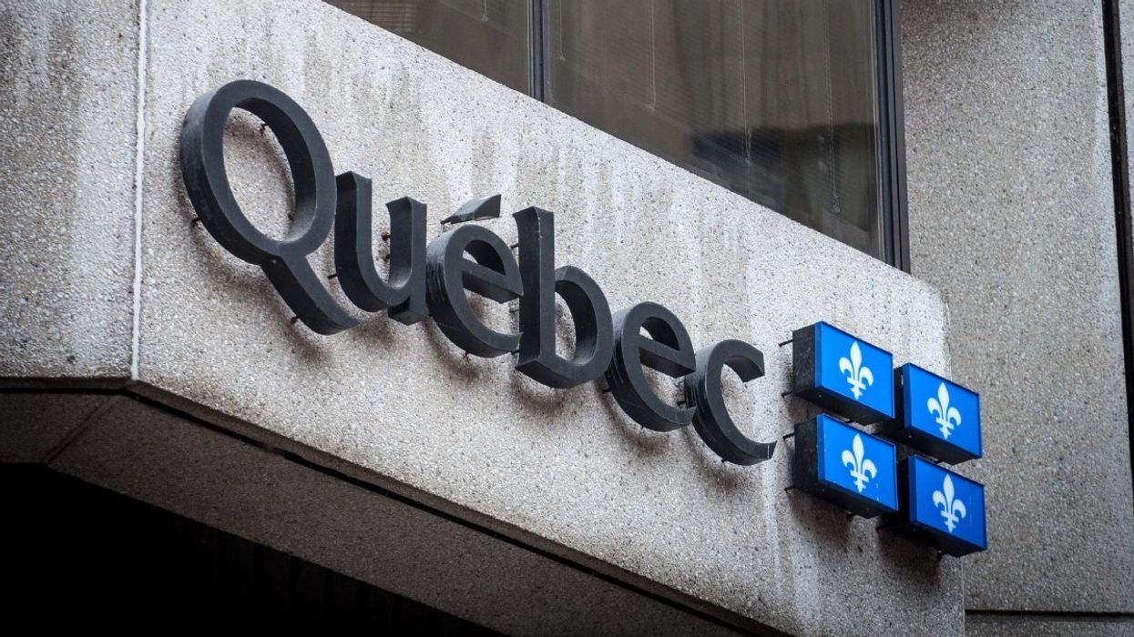 The exterior of a Quebec government building with the official logo of the Quebec flag.