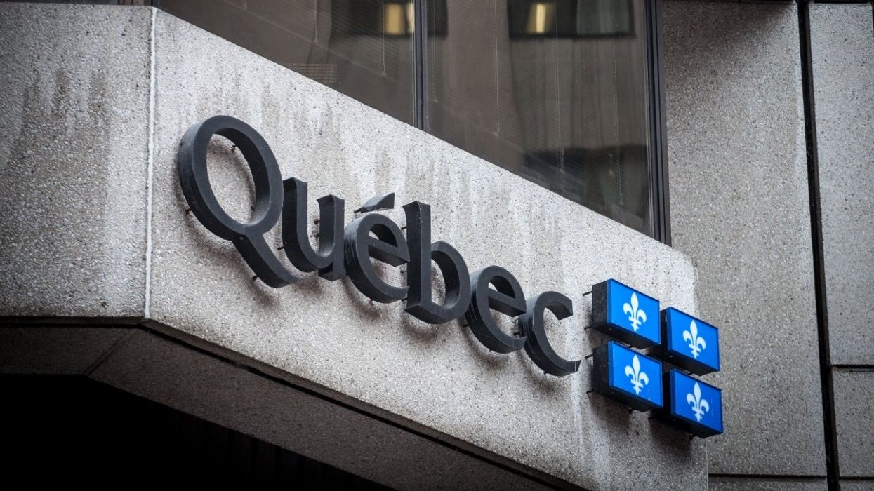 The exterior of a Quebec government building with the Quebec flag.