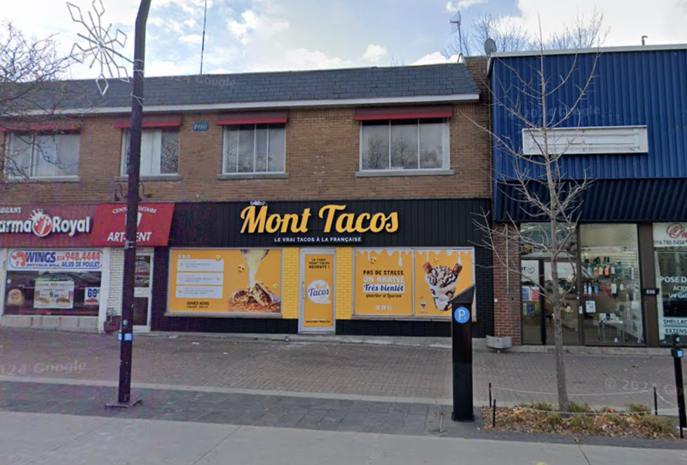 The exterior of a taco restaurant in Montreal painted in yellow and black on a busy street.