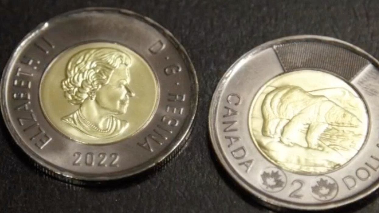 The front and back of the new black $2 coins.