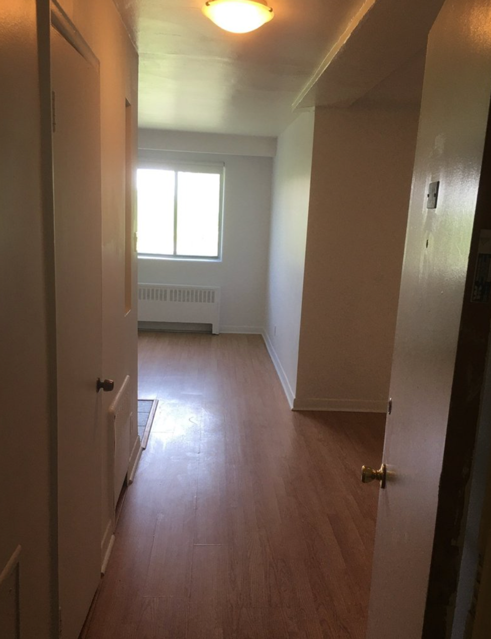 The hallway and bedroom in a Villeray one-bedroom apartment.